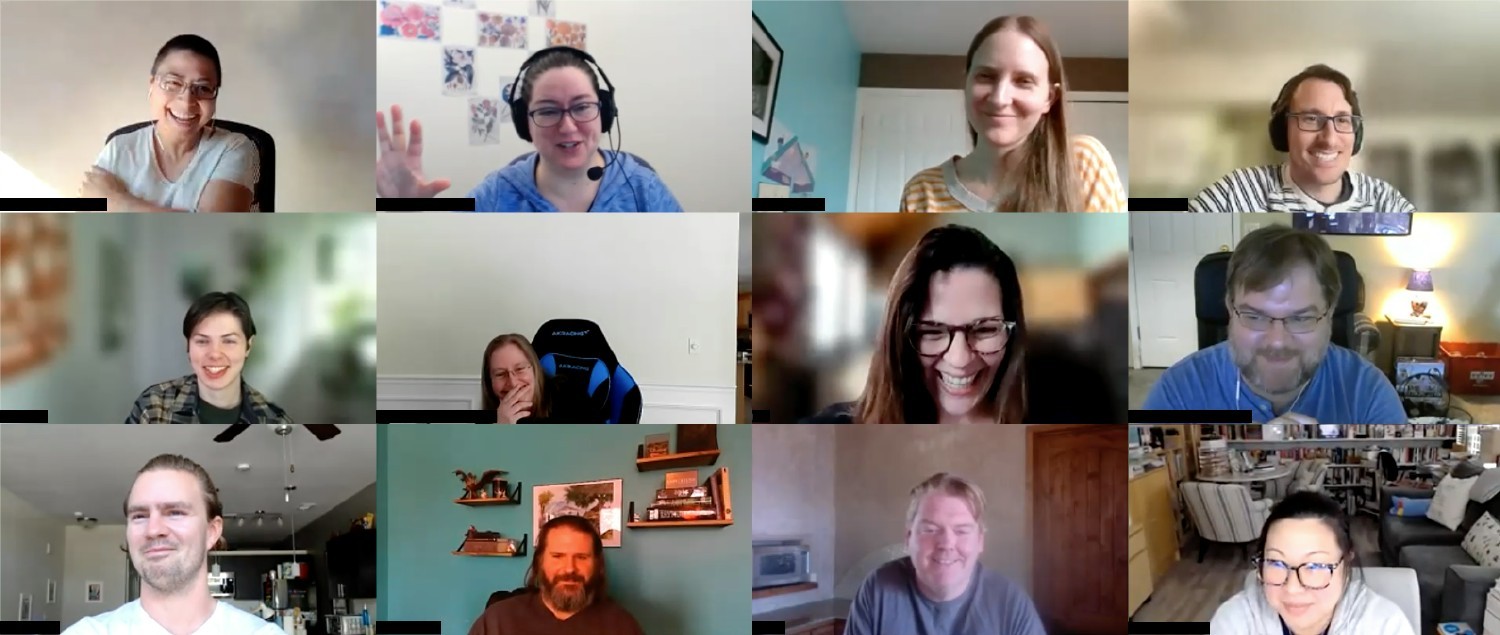 Photo of smiling and laughing team members at a virtual meeting